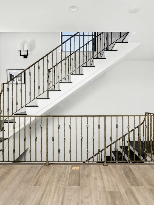 Wooden staircase with metal railing on top and bottom